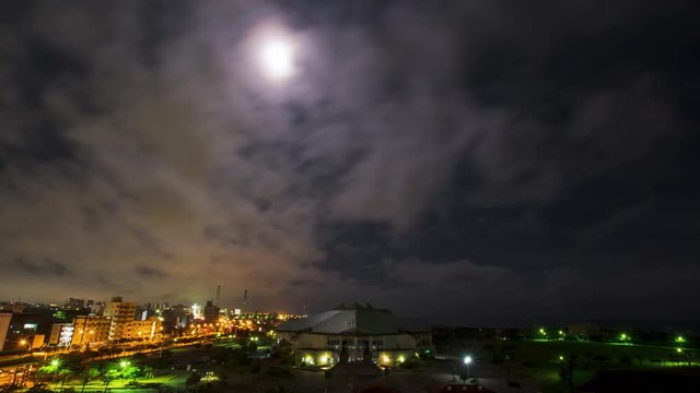 Timelapse of clouds over city at night, Okinawa, Japan