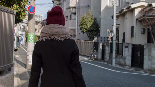 View of woman walking on street, Tokyo, Japan