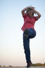 Full-length woman dancing on a rural holiday