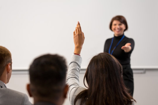 Business, Education And People Concept - Smiling Businesswoman Or Teacher Answering Questions At Conference Presentation Or Lecture