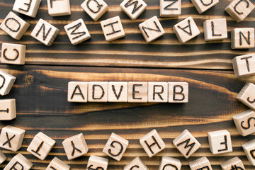 Adverb - word from wooden blocks with letters, describes or gives more information concept, random...