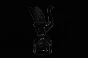 crystal glass on delivery in the form of a goose close-up on black background