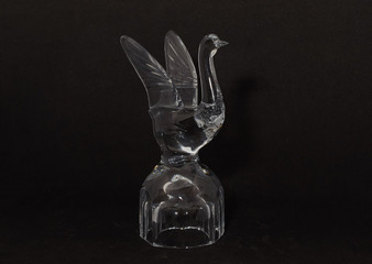 crystal glass on delivery in the form of a goose close-up on black background © Татьяна Громова