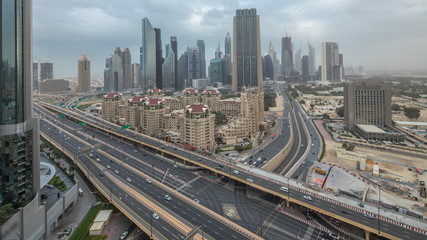 Naklejka na ściany i meble Dubai downtown skyline night to day aerial timelapse with traffic on highway