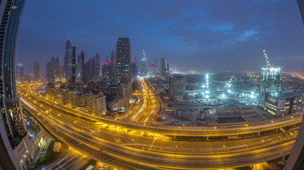 Obraz premium Dubai downtown skyline night to day aerial timelapse with traffic on highway