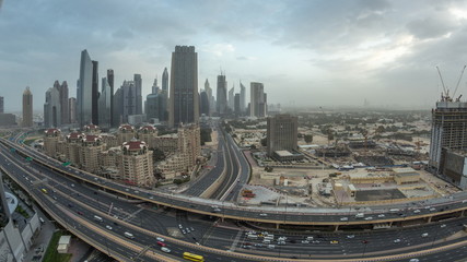 Naklejka na ściany i meble Dubai downtown skyline night to day aerial timelapse with traffic on highway