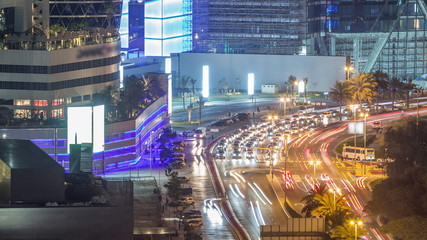 Fototapeta na wymiar Skyline view of intersection traffic on Al Saada street near DIFC night timelapse in Dubai