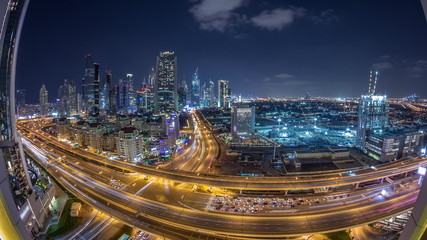 Fototapeta premium Skyscrapers aerial view in downtown and financial district Dubai night timelapse, United Arab Emirates