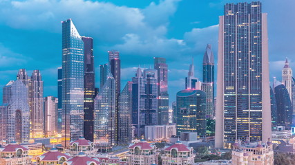 Fototapeta na wymiar Skyline view of the buildings of Sheikh Zayed Road and DIFC night to day timelapse in Dubai, UAE.