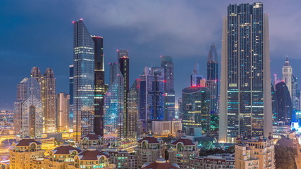 Skyline view of the buildings of Sheikh Zayed Road and DIFC night to day timelapse in Dubai, UAE.
