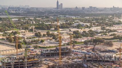 Construction activity in Dubai downtown with cranes and workers timelapse, UAE.