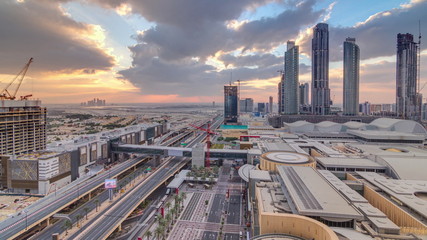 Obraz premium Sunrise aerial view of Financial center road morning timelapse with under construction building