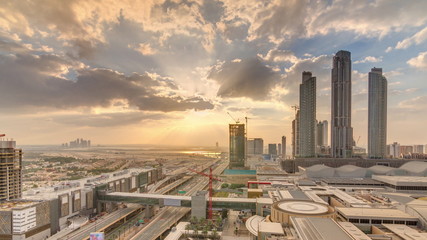 Obraz premium Sunrise aerial view of Financial center road morning timelapse with under construction building