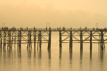Landscape of the wooden bridge in the morning during the sunrise. The Mon Bridge at Sangkhla Buri District Kanchanaburi Province, Thailand.