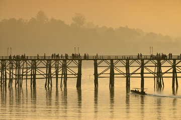 Landscape of the wooden bridge in the morning during the sunrise. The Mon Bridge at Sangkhla Buri District Kanchanaburi Province, Thailand.