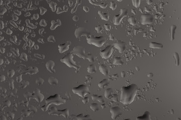 Closeup macro photo of water drops captured on glass window with dark background overlooking city street.