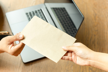 Obraz premium Businessman taking bribe money in brown envelope from partner.