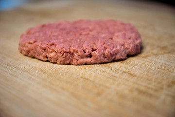 Single vegan and plant based burger on a wooden plate