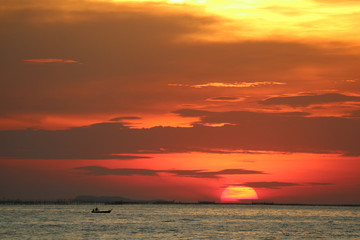 sunset on red yellow sky back evening cloud over horizon sea