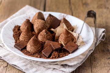 Chocolate Truffles Tasty Candy Homemade Truffles and Chocolate on White Plate Old Wooden Background Horizontal