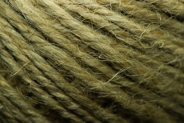 Close-up macro view of twine or string from natural fabric wrapped in a ball.