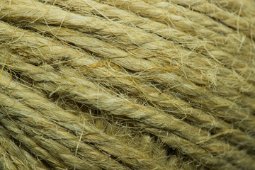 Close-up macro view of twine or string from natural fabric wrapped in a ball.