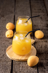Two Glasses of Fresh Tasty Apricot Juice on the Wooden Background Healthy Diet Drink Vertical
