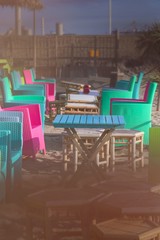 Summer terrace cafe, colorful multi colored chairs and tables outside. Concept food