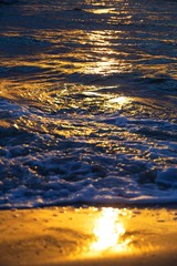 Waves and rays of a sun are reflected in the sea