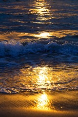 Waves and rays of a sun are reflected in the sea