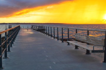 Obraz premium Dramatic summer sunset over sea. Scenic landscape with pier on the sea during beautiful sunset. Sweden