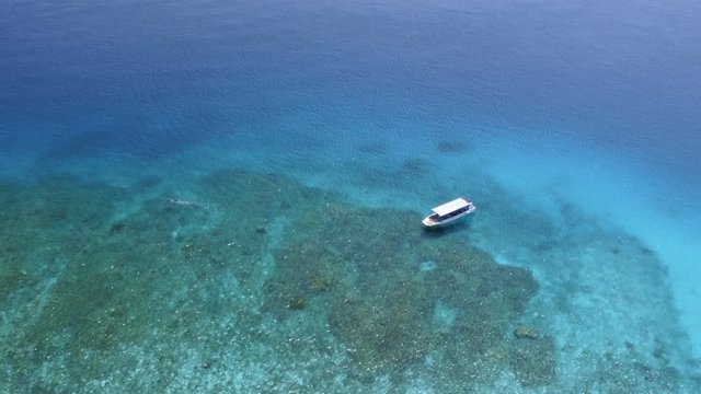 Aerial shot of motorboat in sea, Zamami Island, Okinawa, Japan