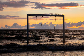 Swing on beautiful sunset sea and beach, Sweden, Helsingborg