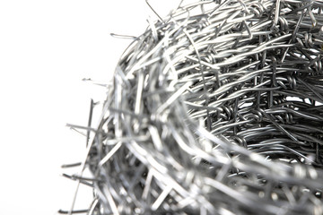Close up A bundle of Galvanized Barbed Wire or Barb Wire Fencing with sharp edges isolated on white background.