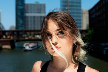 Beautiful Young Caucasian Girl with Barbell septum Nose Ring (Horseshoe Nose Ring) in Windy City at a sunny summer day.