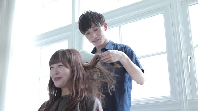 Hairdresser working with hair of customer