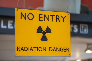 Yellow radiation warning and hazard sign forbidding entry to a radioactive zone