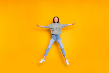 Fototapeta na wymiar Full length body size photo of jumping excited girlfriend having taken shape of star while isolated with yellow vivid background