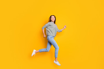 Full length body size photo of excited cheerful girlfriend running towards her dreams while isolated with yellow background