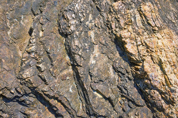 Texture of coastal mountain cliff in Montenegro on a sunny day, background
