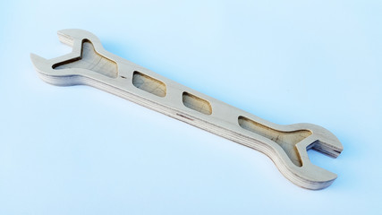 Wrench. Wrench made of plywood. Wrench made of plywood on a light background