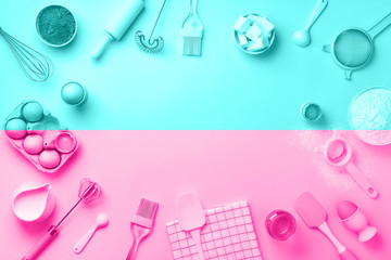 Bakery ingredients over trendy neon pink and blue color background - butter, sugar, flour, eggs, oil, spoon, rolling pin. Baking frame, cooking concept. Top view, copy space. Flat lay