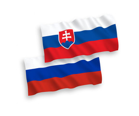 Fototapeta premium National vector fabric wave flags of Slovakia and Russia isolated on white background. 1 to 2 proportion.