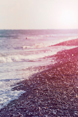 Light waves on the rocky seashore at sunset