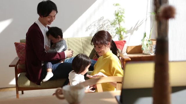 Parents playing with children in living room