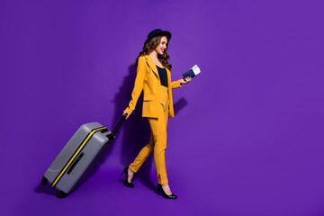 Profile side full length body size view of nice attractive elegant cheerful cheery wavy-haired lady boarding time journey walking motion isolated on bright vivid shine violet lilac background