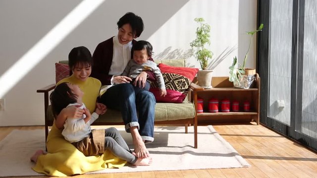 Parents playing with children in living room