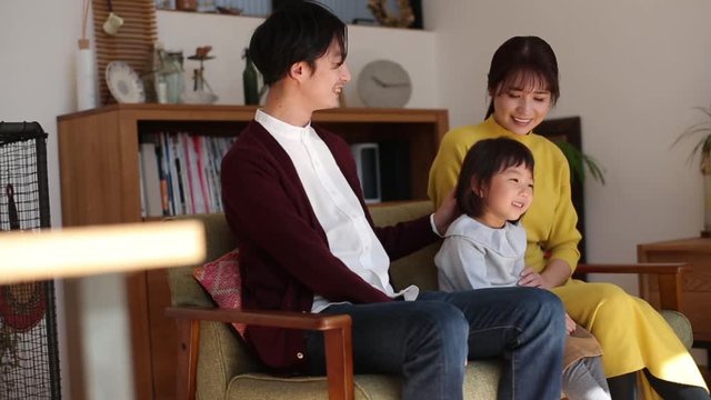 Family sitting together on sofa