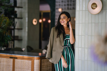 Portrait of a tall, slim, elegant and beautiful Indian Asian woman in an elegant jumper with a...