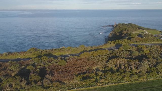 4k aerial footage along winding coastal road and countryside.